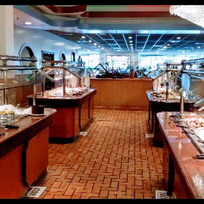 Buffet trays with Chinese dishes and sushi.